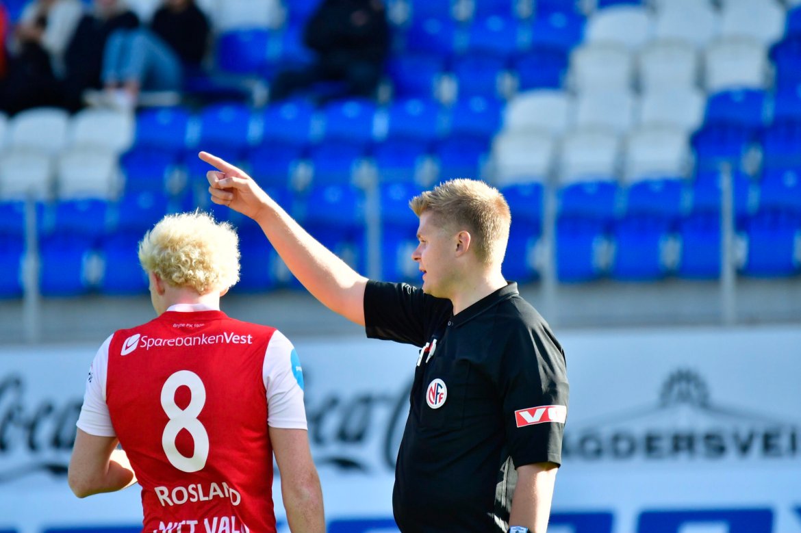 DØMT:  Dommer Henrik Andreas Grenå Pettersen forklarer Bryne-spiller Erik Rosland hvor skapet skal stå.